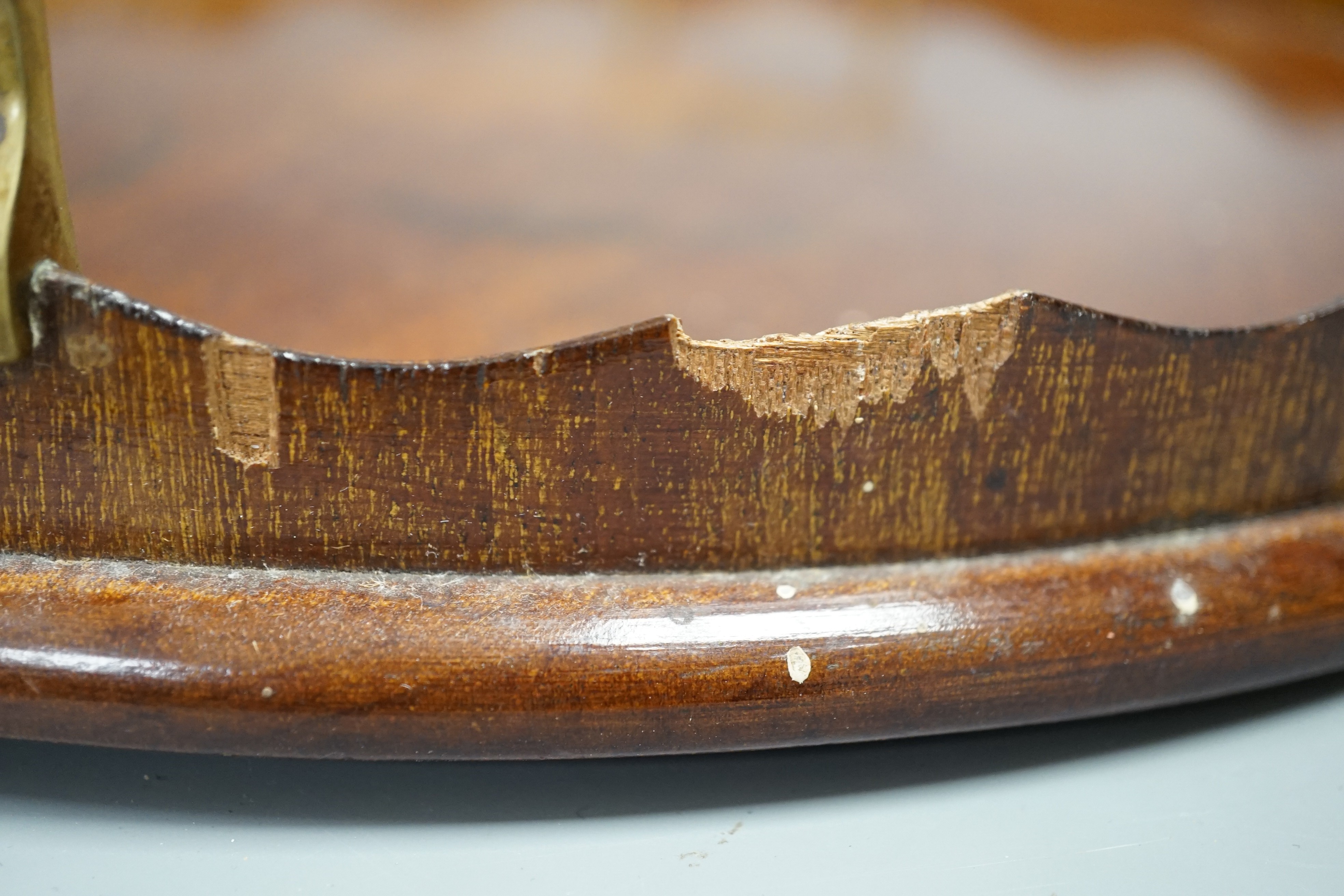 A circular shell inlaid, pie crust edged, brass handled, mahogany tray, 34.5 cms diameter